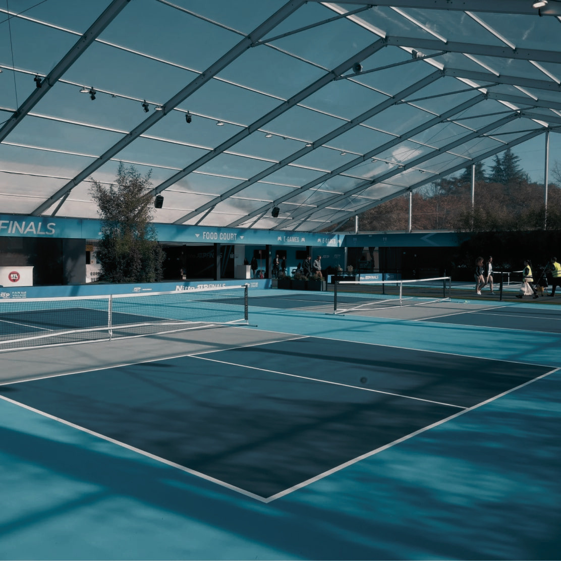 Championship-grade GreenSet tennis surface where champions compete