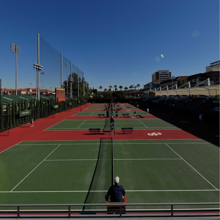 USC outdoor tennis courts surfaced by GreenSet — cardinal red surrounds with green play areas